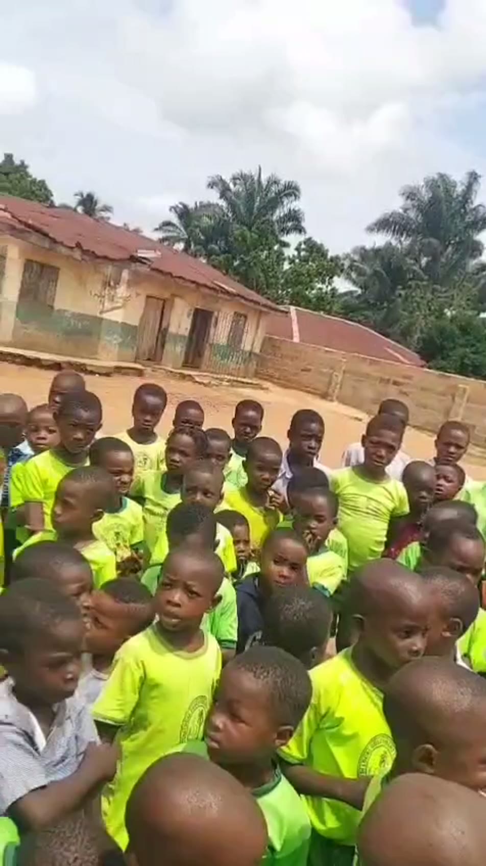 A large crowd of pupils outside the school compound